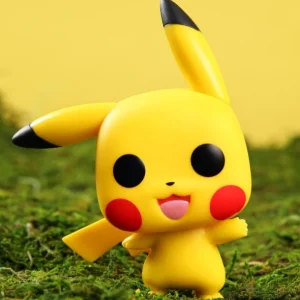 Pokémon Pikachu Funko Pop vinyl figure standing on moss with an open mouth and waving arm