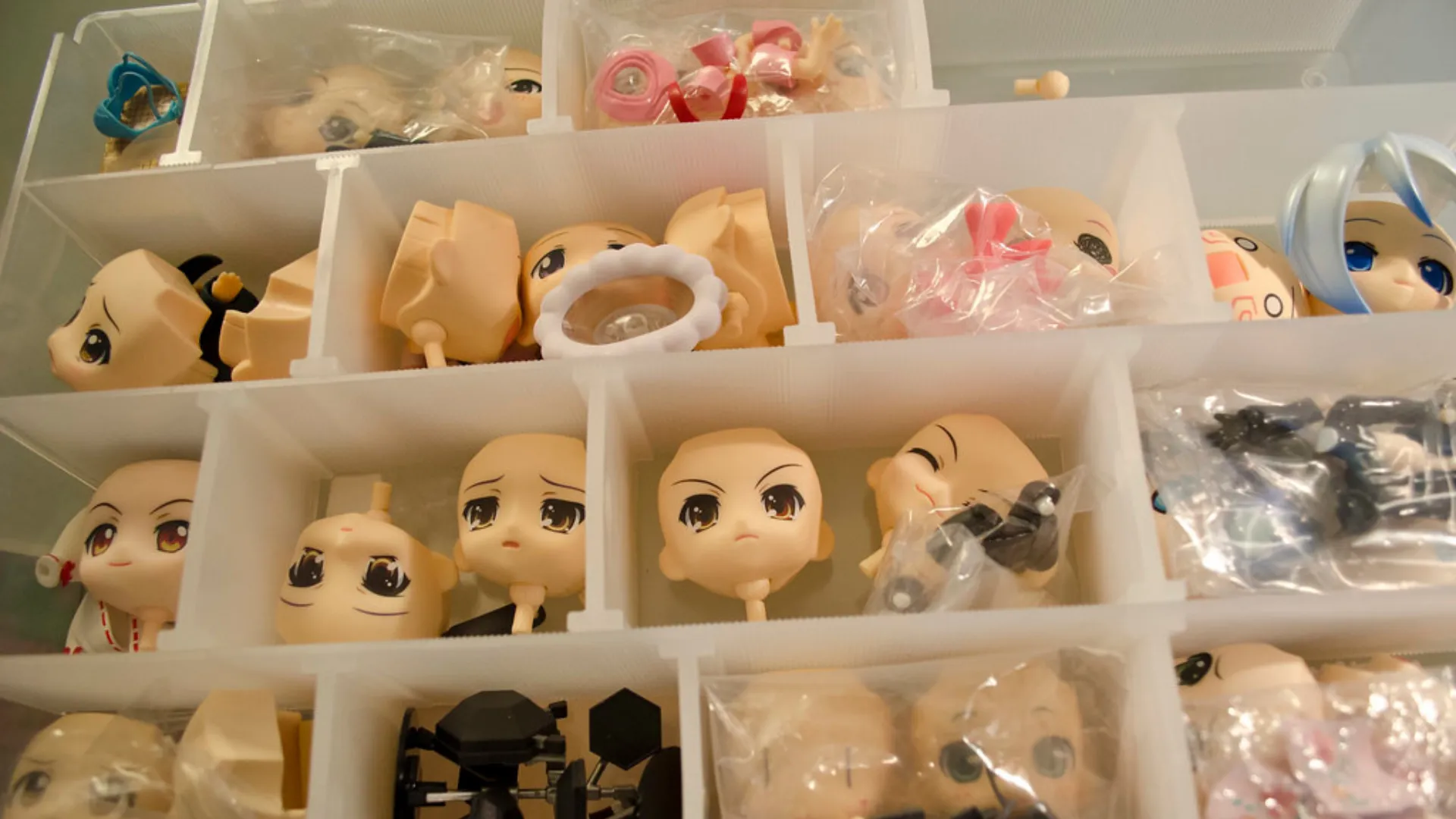 nendoroid spare parts blog Nendoroid faceplates and spare anime figure parts organized in white plastic storage drawers